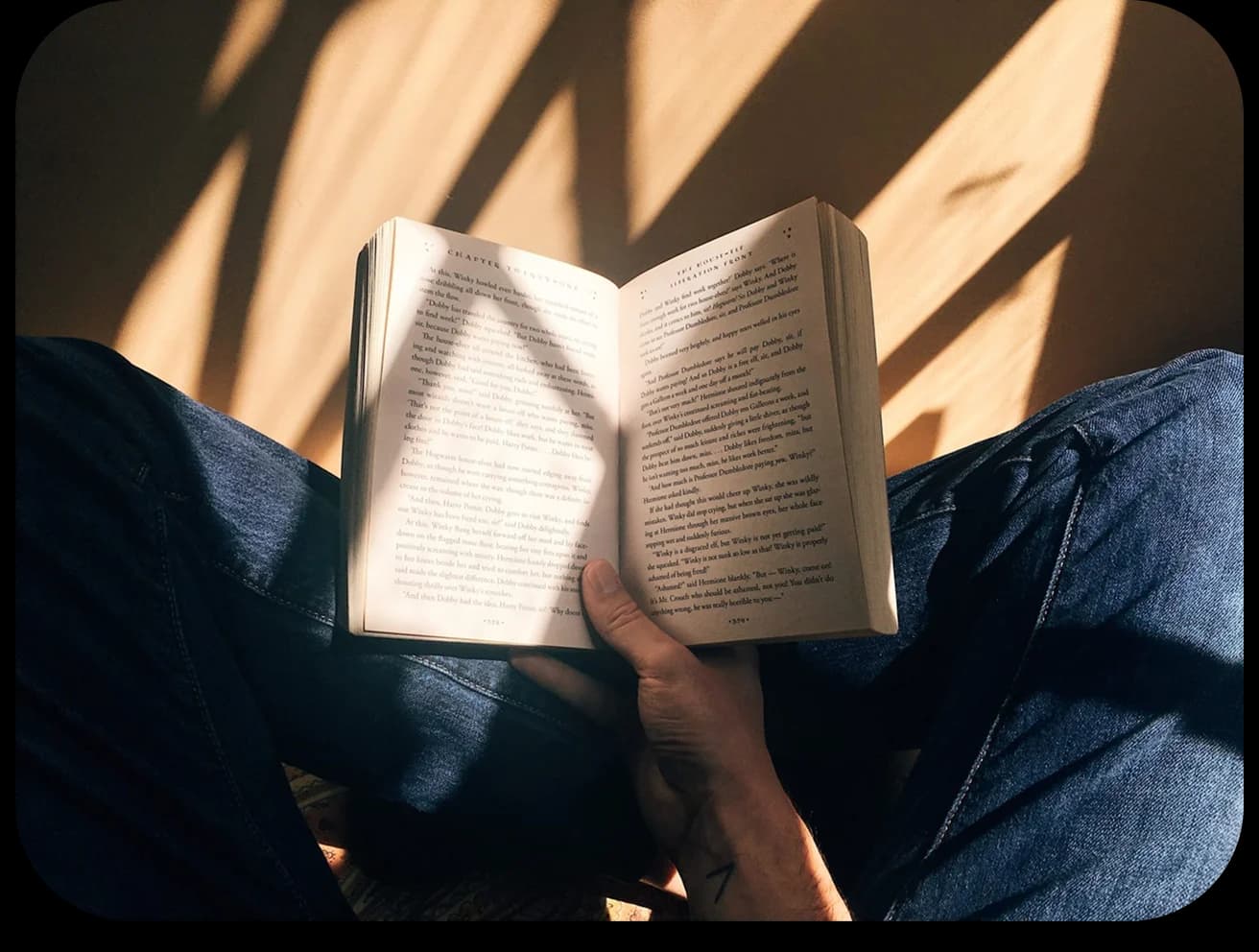 Person holding an open book