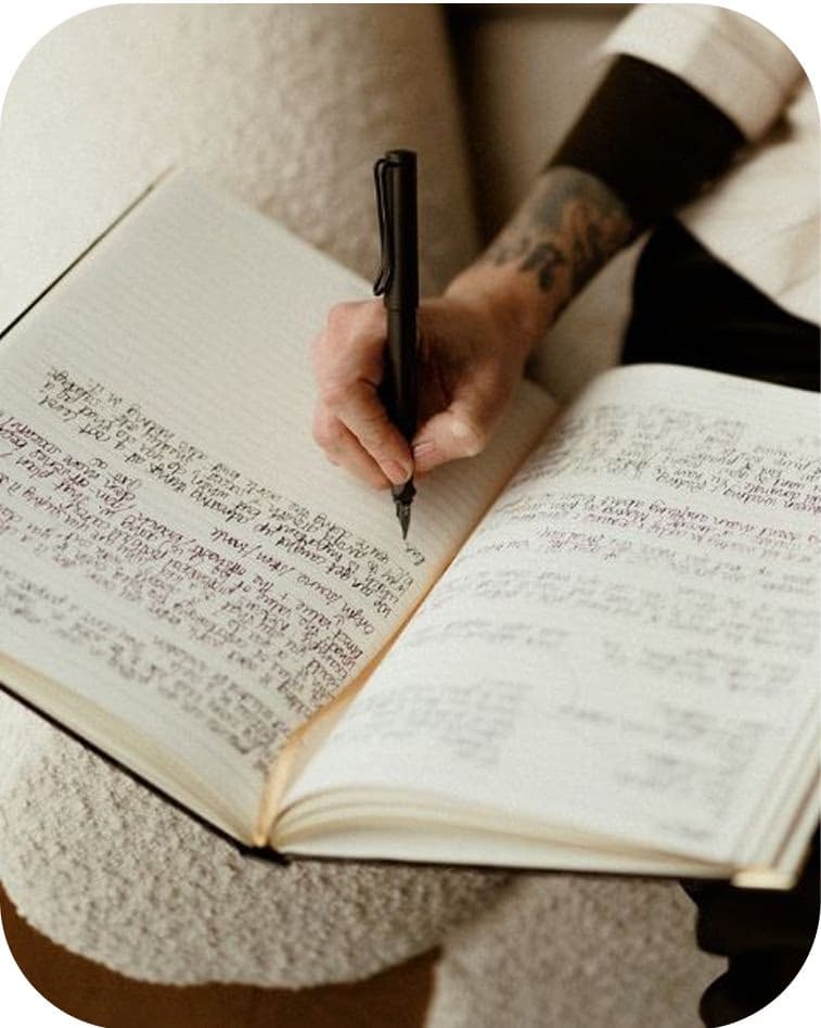 Person writing in book