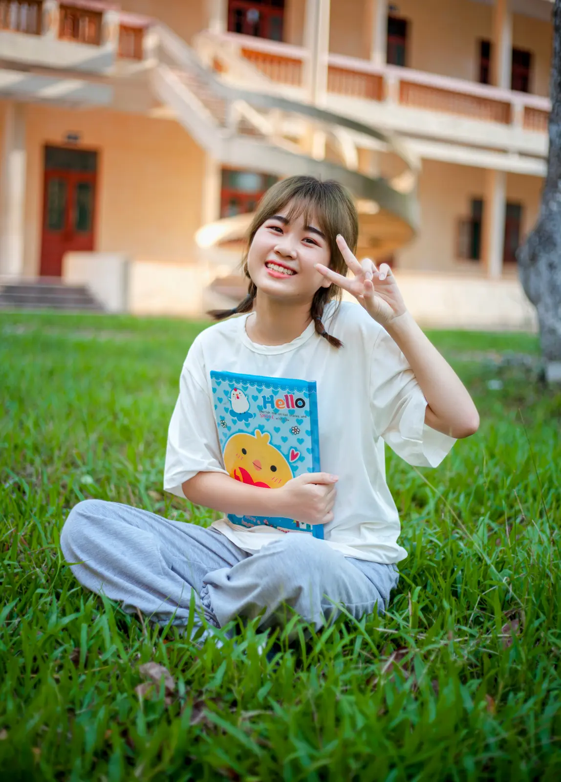 Asian girl smiling while doing peace sign