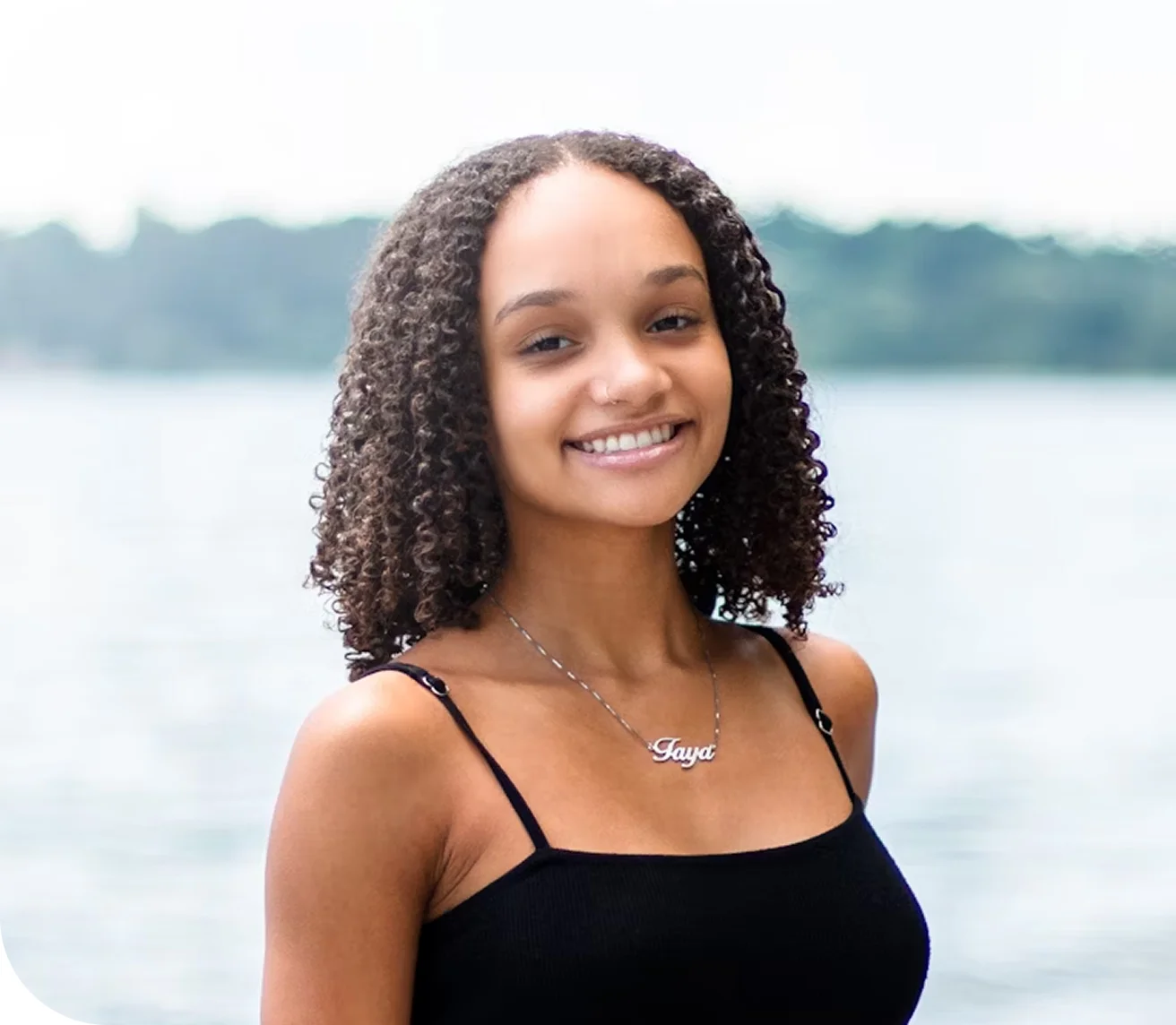 Girl smiling with water in the background