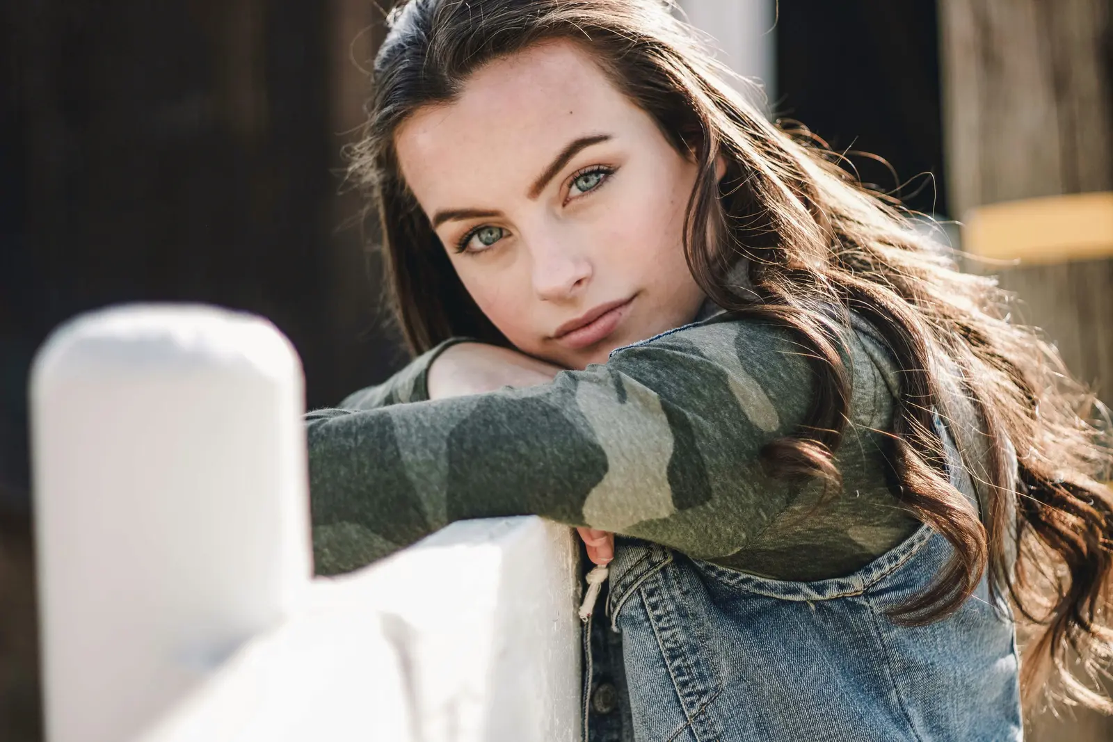 Woman smiling leaning on fence